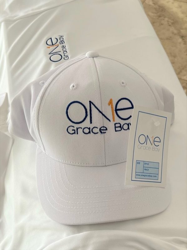 one grace bay cap and golf shirt on table with price ticket